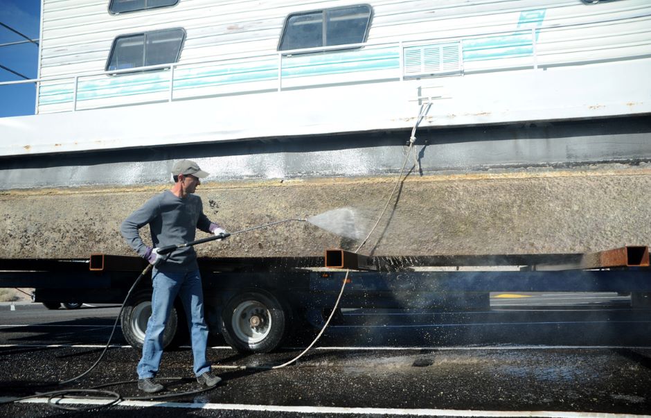 Shawn Bagley, conservation officer, Utah Division of Wildlife Resources, removes quagga mussels (an invasive species) from a boat during a Watercraft Inspection Training course at Lake Mead Nov. 14, 2012