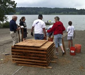 Agencies and volunteers partnered to build and install 20 crib structures for fish habitat in Pennsylvania's Woodcock Creek Lake